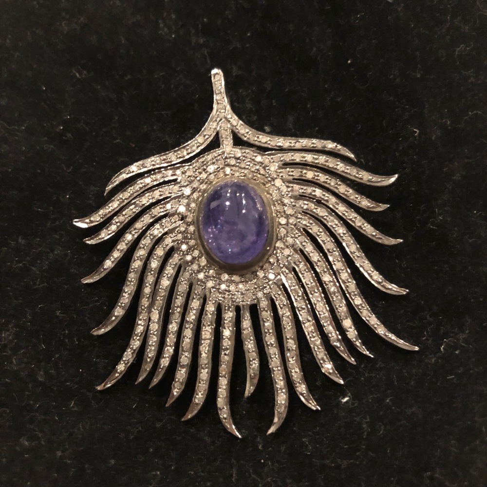 Cabochon tanzanite and diamond feather pendant